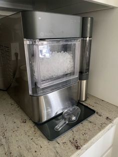 an ice maker is sitting on top of a counter