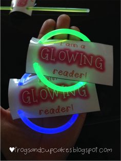 glow in the dark stickers are being held up by someone's hand,