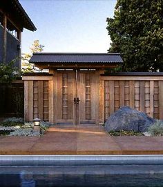 a small wooden building sitting next to a pool