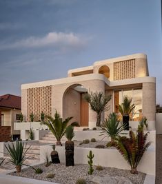 a house with plants and rocks in front of it