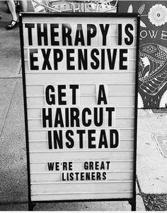 a sign on the sidewalk that says therapy is expensive get a haircut instead we're great listeners