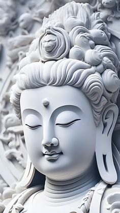 a white buddha statue sitting in front of a wall