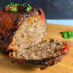 the meatloaf is sliced and ready to be eaten on the cutting board for consumption