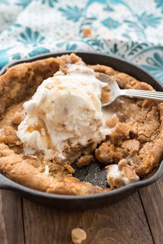 a skillet filled with ice cream on top of a wooden table