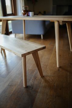 a wooden bench sitting on top of a hard wood floor