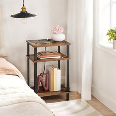 a bed room with a neatly made bed and a book shelf next to the bed