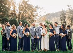 a group of people that are standing in the grass