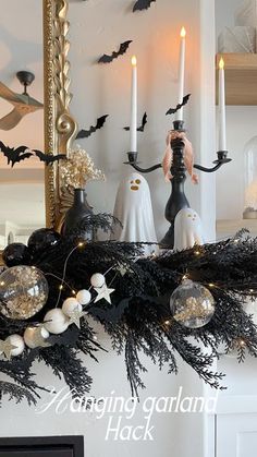 the mantle is decorated with black and white decorations, candles, and fake birds on it