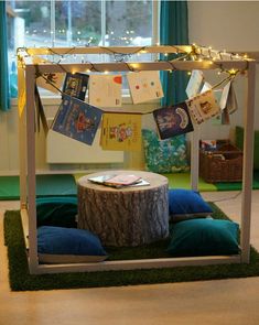 a tree stump with some cards hanging from it's sides in front of a window