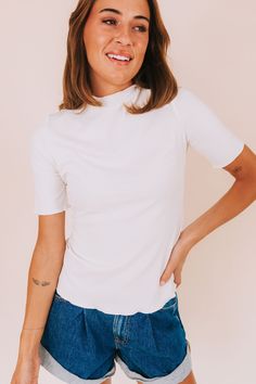 Show off your flirty side with our Beautiful Spirit Top! Made with ribbed fabric and detailed with scalloped edges, this top will add a touch of playfulness to any outfit. Complete with a mock neckline, it's the perfect balance of chic and fun. Details Ribbed Scalloped edges Mock neckline Sizing Approximate measurements: SIZE LENGTH BUST Small 23" 34" Medium 23.5" 36" Large 24" 38" XLarge 25" 42" Fabric has stretchModel is 5’10 wearing small Material 65% Rayon 30% Polyester 5% SpandexHand wash c Chic Ribbed Fitted Mock Neck Top, Chic Ribbed Turtleneck Tops, Chic High Neck Ribbed Tops, Chic Ribbed High Neck Top, Chic Stretch Ribbed Mock Neck Top, Stretch Turtleneck Top With Ribbed Neckline, Spring Ribbed Mock Neck Top For Layering, Trendy Fitted Ribbed Mock Neck Top, Fitted White Turtleneck Top