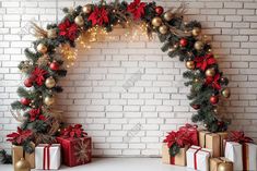 christmas decorations and presents are arranged in front of a white brick wall with lights on it