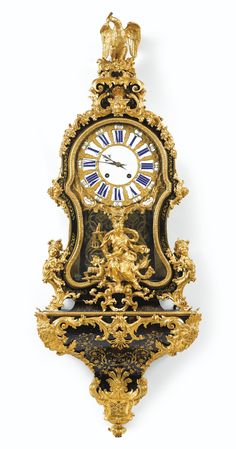 an ornate gold and black clock with figures on it's face, against a white background