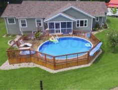 an above ground pool surrounded by decking and landscaping