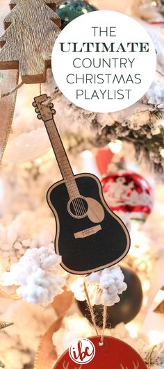 the ultimate country christmas playlist with an acoustic guitar ornament hanging from a tree