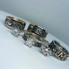 three wedding rings with different designs on each one and the other side, sitting next to each other