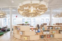 an office filled with lots of books and people sitting on the couches in front of them