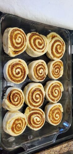 several cinnamon rolls in a glass baking dish