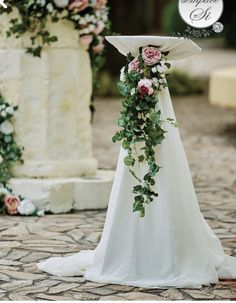 a white wedding dress with pink flowers on it