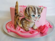 a cake decorated with a cat on top of it