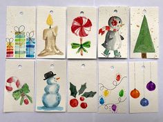 six christmas tags with watercolor designs on them, each featuring a snowman holding a candy cane