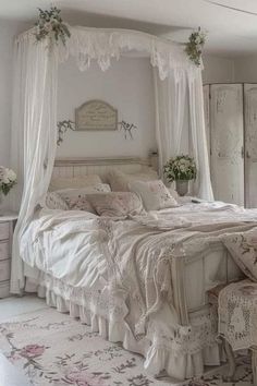 a white bed sitting in a bedroom next to a dresser and chair with flowers on it