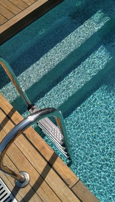 an empty swimming pool with steps leading up to the edge and water running down it