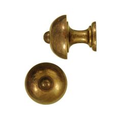 two antique brass door knobs on a white background