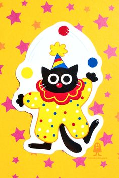 A vinyl sticker depicting a black cat dressed as a clown juggling. The style is simple and cartoony, the cat is wearing a red nose, a yellow clown suit with red, blue, and white polka dots and juggling. It is also wearing a striped party hat with a pompom and a red ruff collar. A Black Cat, Vinyl Stickers, Circus, Black Cat, Art Inspo, Vinyl Sticker