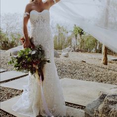 a woman in a wedding dress holding a veil