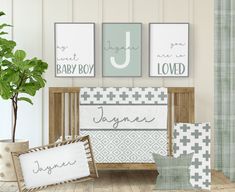 a baby crib with three pictures on the wall and two pillows in front of it