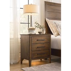 a night stand with two drawers and a lamp