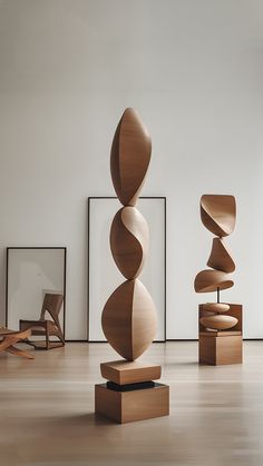 several wooden sculptures in an art gallery