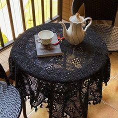 a table with a tea pot on top of it next to a cup and saucer