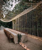 a long table with candles and lights on it