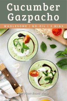 two glasses filled with cucumber gazpacho and topped with whipped cream