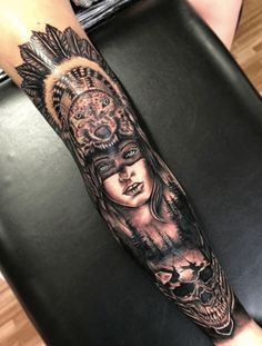 a woman with an owl and skull tattoo on her arm