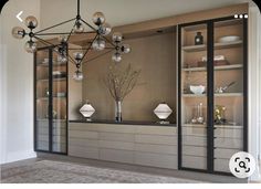 a living room filled with furniture and lots of glass shelves on top of each other