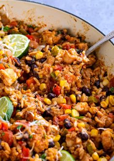 a skillet filled with mexican rice and vegetables