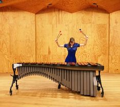 a woman is playing an instrument on a table