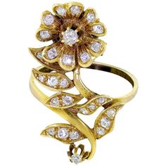 a gold ring with diamonds and leaves on the front, set in 18k yellow gold