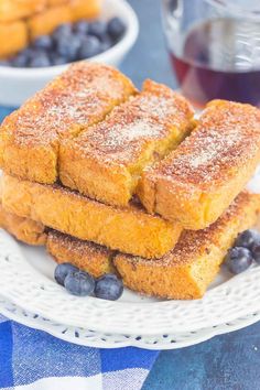 three pieces of french toast on a plate with blueberries