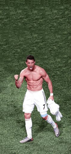 a shirtless male soccer player is running on the field