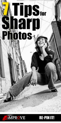 a woman sitting on the ground next to a building with her hand under her chin