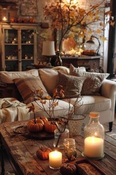 a living room filled with lots of furniture and candles on top of a wooden table