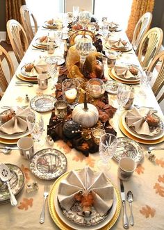 a table set for thanksgiving dinner with plates and silverware