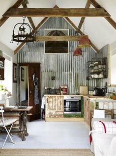 an instagramted photo of a kitchen and dining area in a house with exposed wood beams