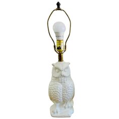 an owl lamp with a light bulb on it's head and a white background