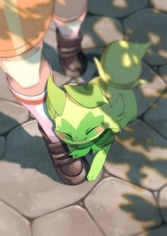 an animated image of a green cat sitting on top of a person's leg