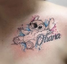 a woman with a tattoo on her chest that says ohana and an image of a teddy bear