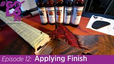 a wooden table topped with bottles and a knife on top of it next to a piece of paper